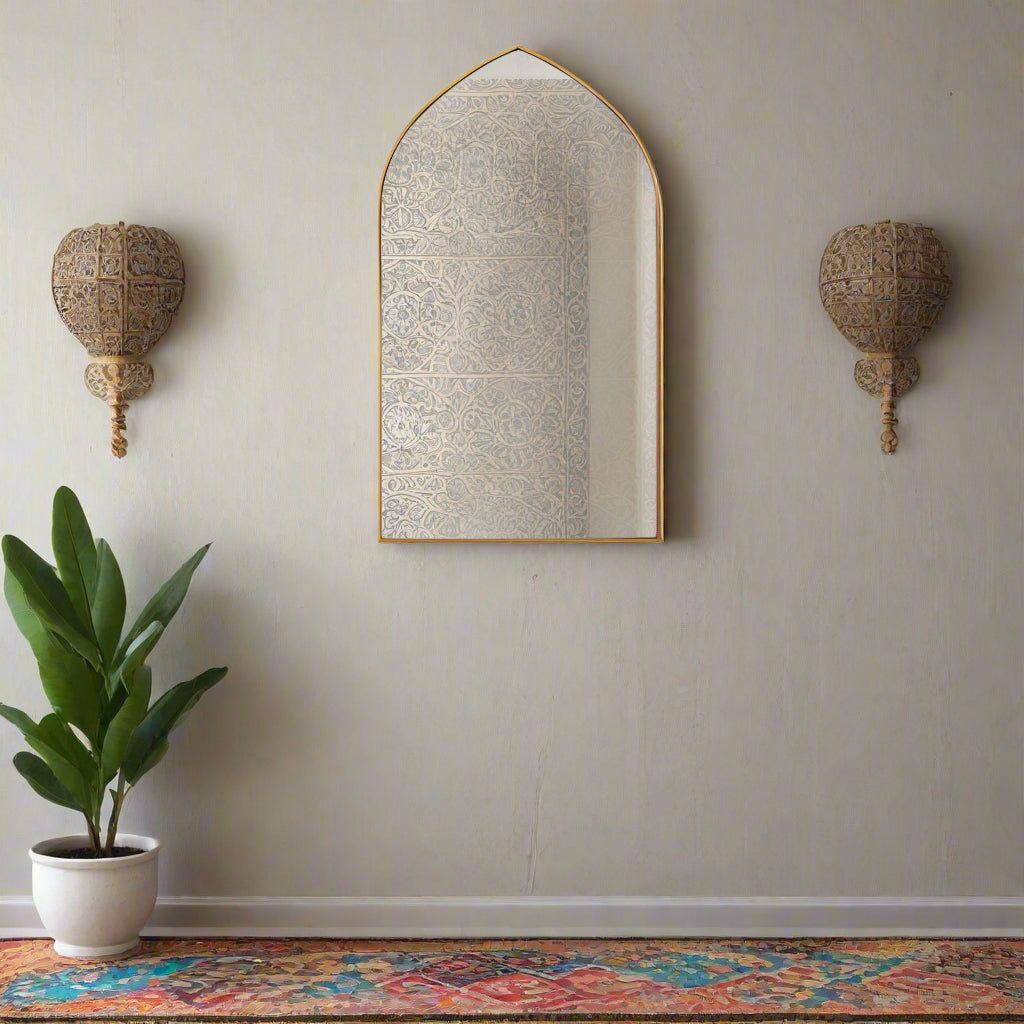 Gold gilt metal framed arched wall mirror, in a wall