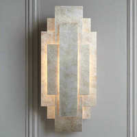 Silvered Deco Wall Light in Art Deco style with layered geometric panels and aged silver finish, ideal for ambient lighting in traditional interiors.