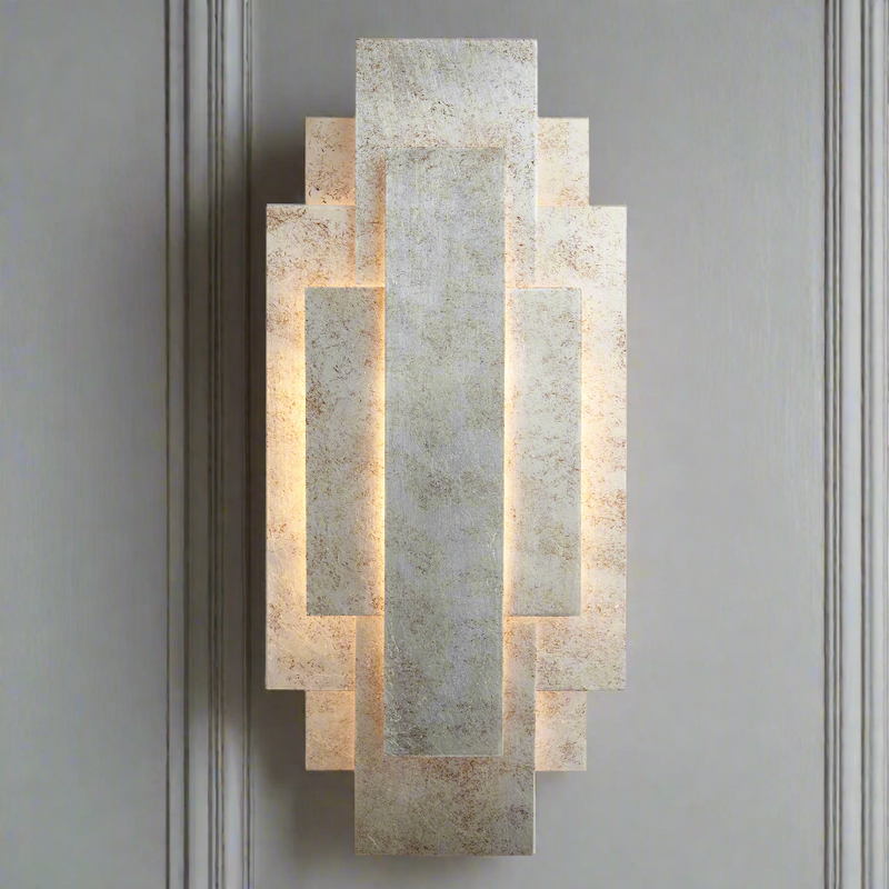 Silvered Deco Wall Light in Art Deco style with layered geometric panels and aged silver finish, ideal for ambient lighting in traditional interiors.