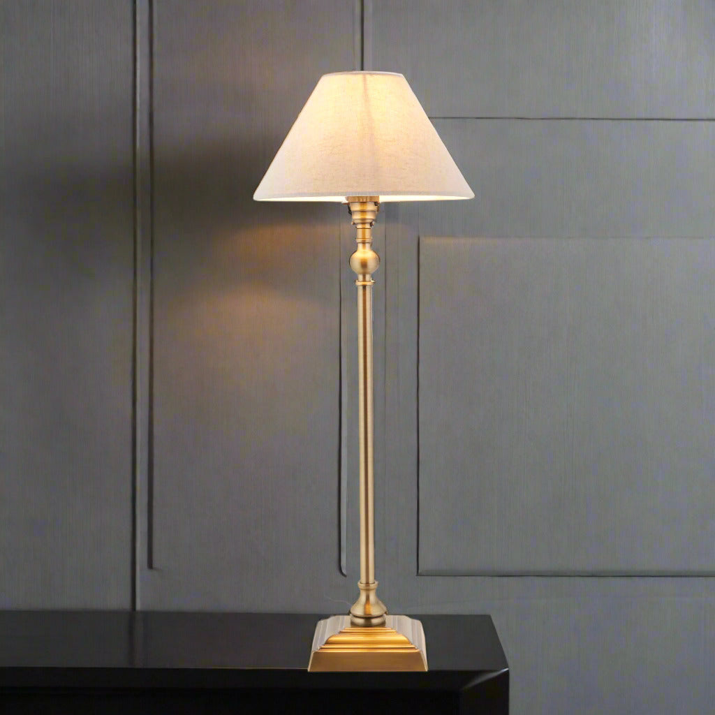 A classic, antique brass, column table lamp with linen shade. Perfect bedside lamp, the right size and shape for most bedside tables. A really traditional lamp.