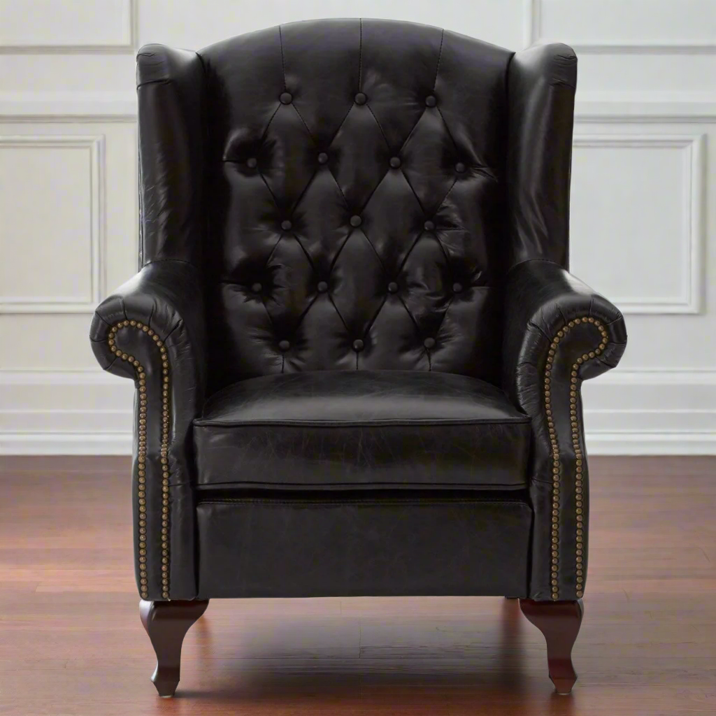 A replica of a typical Victorian button back armchair, in black leather with antique studding. Large and immensely comfortable. A great 'Gentlemen's Club' chair for the home.