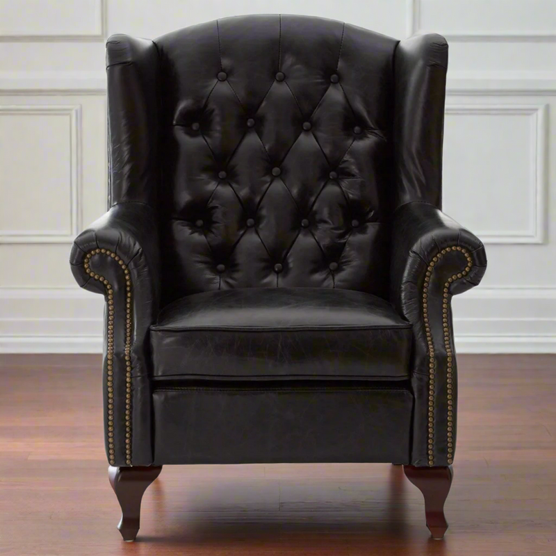 A replica of a typical Victorian button back armchair, in black leather with antique studding. Large and immensely comfortable. A great 'Gentlemen's Club' chair for the home.