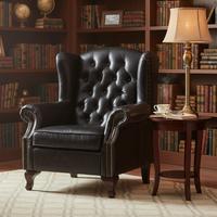 A replica of a typical Victorian button back armchair, in black leather with antique studding. Large and immensely comfortable. A great 'Gentlemen's Club' chair for the home.