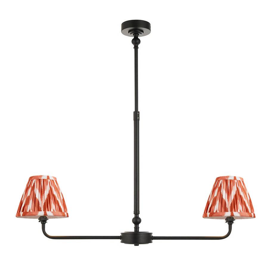 A refined ceiling light featuring an matt black frame with two curved arms, each supporting a classic tapered fabric clip shade.