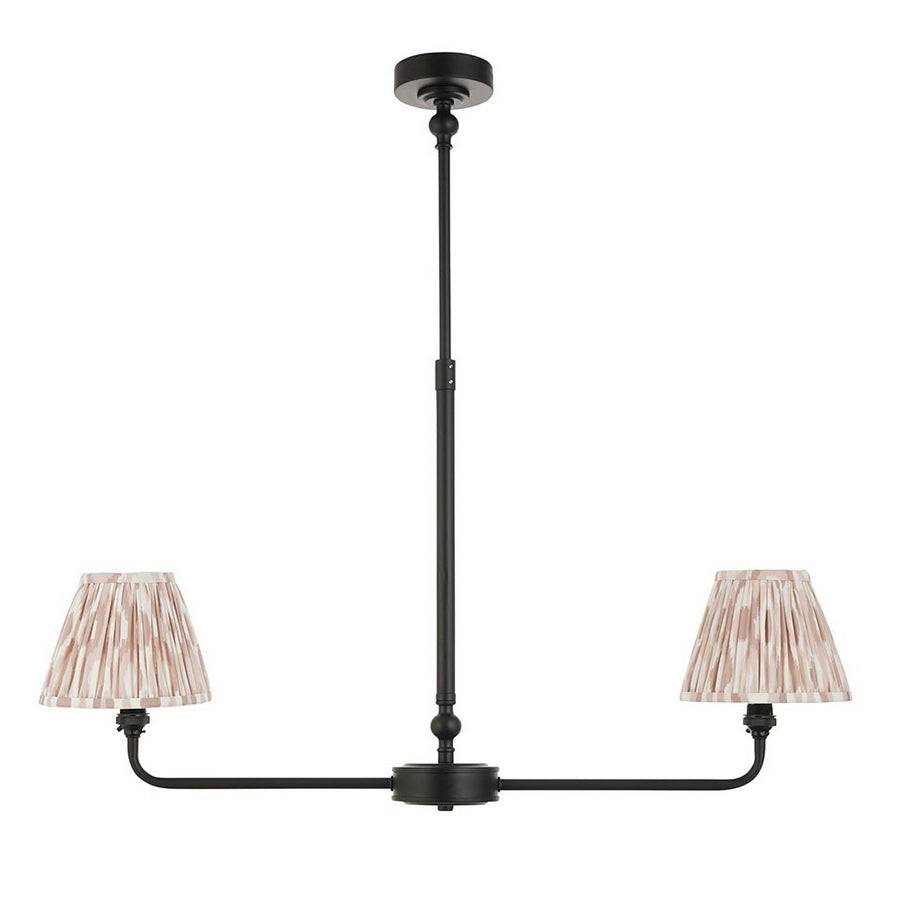 A refined ceiling light featuring an matt black frame with two curved arms, each supporting a classic tapered fabric clip shade.