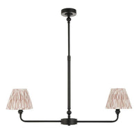 A refined ceiling light featuring an matt black frame with two curved arms, each supporting a classic tapered fabric clip shade.