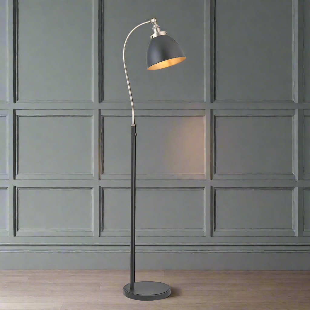 Tall slim profiled, black floor lamp with nickel fittings and gilt inner to the black shade. This lamp is great for a study or to read by, placed by a desk or your favourite chair the light can be directed where it's needed.