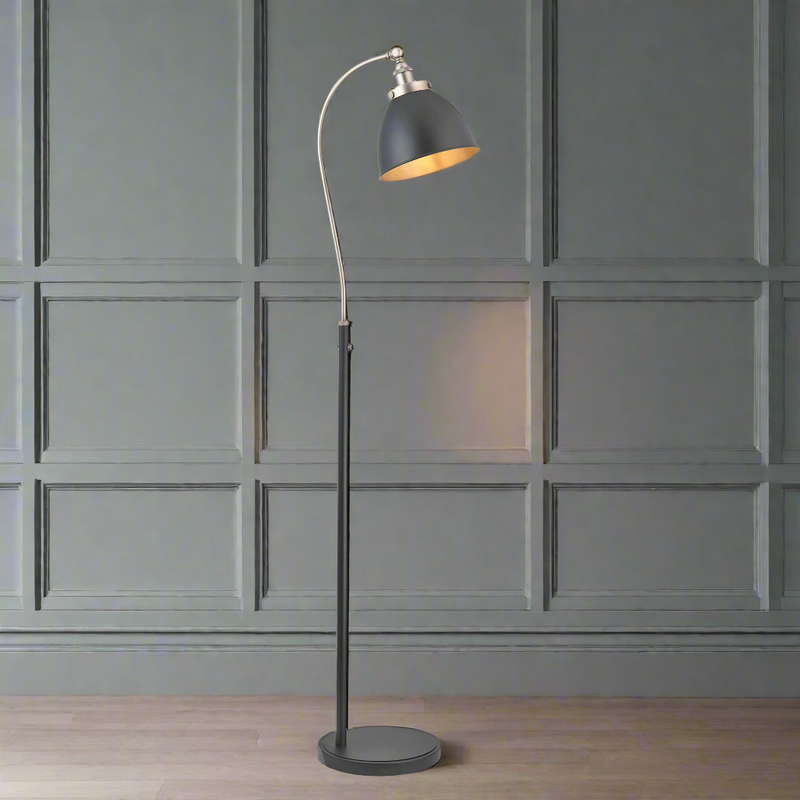 Tall slim profiled, black floor lamp with nickel fittings and gilt inner to the black shade. This lamp is great for a study or to read by, placed by a desk or your favourite chair the light can be directed where it's needed.