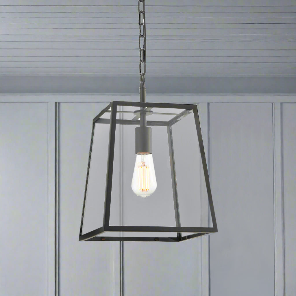 Black trapezoid shaped glass lantern, perfect hall or porch light. It has an industrial twist that suits a period house or the most contemporary interior.