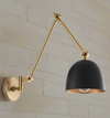 Gold flexible armed wall light with black shade. Industrial style wall light with extended arm. Great living room wall light, perfect in a kitchen or over a dining table.