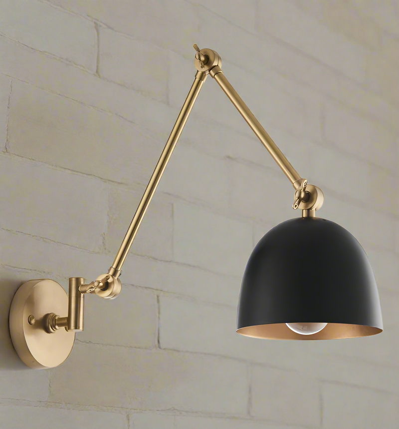 Gold flexible armed wall light with black shade. Industrial style wall light with extended arm. Great living room wall light, perfect in a kitchen or over a dining table.