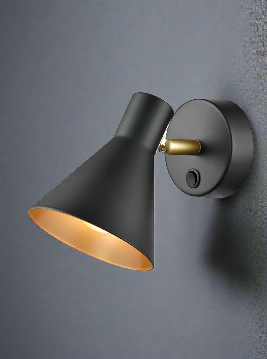 Cone shaped matt black wall light with gilt coloured inner.&nbsp; A single wall light with an integral switch.&nbsp; The spotlight has a full range of motions and can be positioned by hand. The gilt finish on the inside of the spotlight offers a warm glow wherever it is placed 