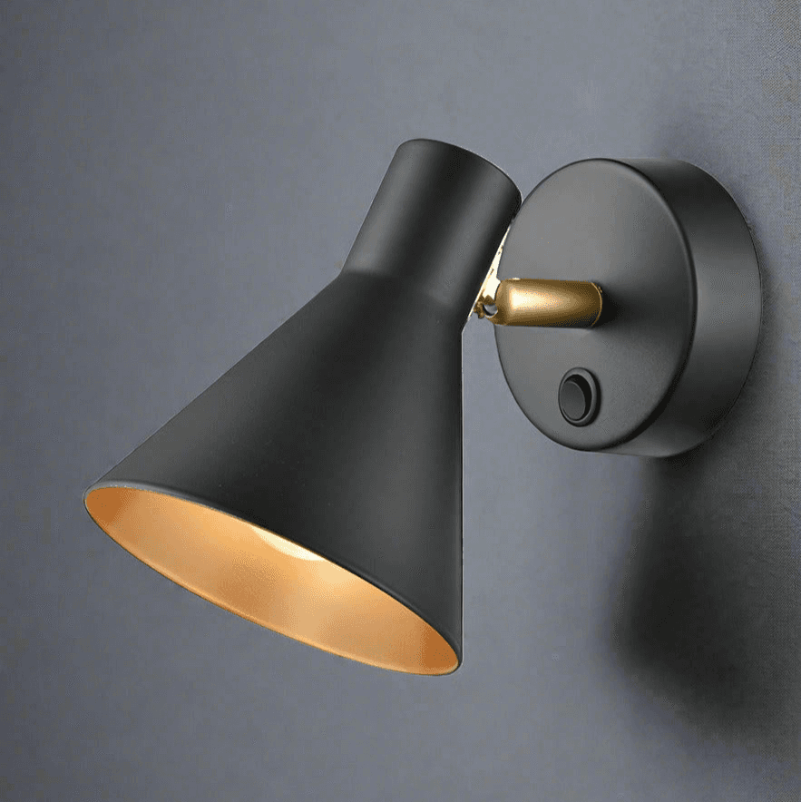 Cone shaped matt black wall light with gilt coloured inner.&nbsp; A single wall light with an integral switch.&nbsp; The spotlight has a full range of motions and can be positioned by hand. The gilt finish on the inside of the spotlight offers a warm glow wherever it is placed 