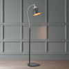 Tall slim profiled, black floor lamp with nickel fittings and gilt inner to the black shade.&nbsp; This lamp is great for a study or to read by, placed by a desk or your favourite chair the light can be directed where it's needed.