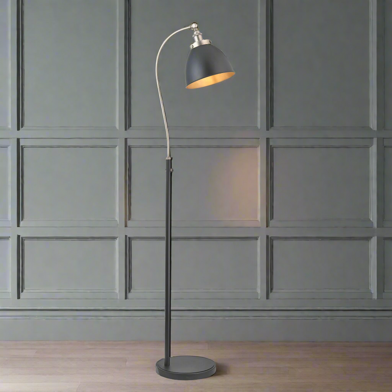 Tall slim profiled, black floor lamp with nickel fittings and gilt inner to the black shade.&nbsp; This lamp is great for a study or to read by, placed by a desk or your favourite chair the light can be directed where it's needed.