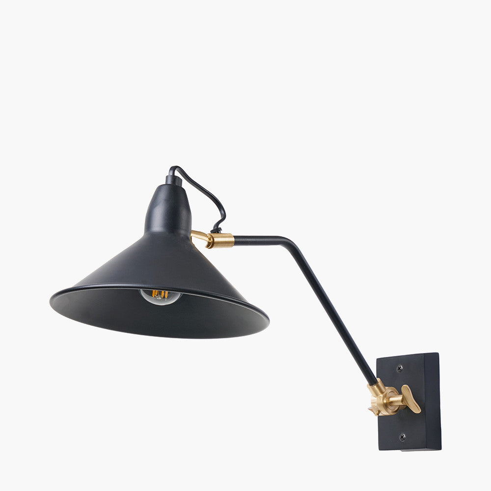 Black industrial styled metal wall light. On an arm with brushed gilt accents, a stunning light perfect in any room.