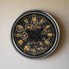 Classic black and gilt moving cog clock with 'Champs Elysee'&nbsp; etched onto the glass front of this stunning clock.&nbsp; Smaller version of the black and gilt moving cog clock at 53 cm, compact and with a touch of luxury.