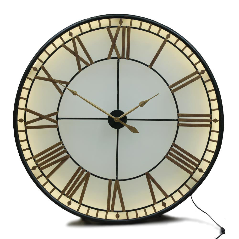 This is an indoor clock where the hands are operated by two standard AA batteries.&nbsp; The iron fascia and hands sit on top of a smoked glass.&nbsp; The batteries are housed in the middle behind the hands - the cross section of which can be pulled out for access.&nbsp;  An led strip light inside requires a power / three pin plug socket.&nbsp;