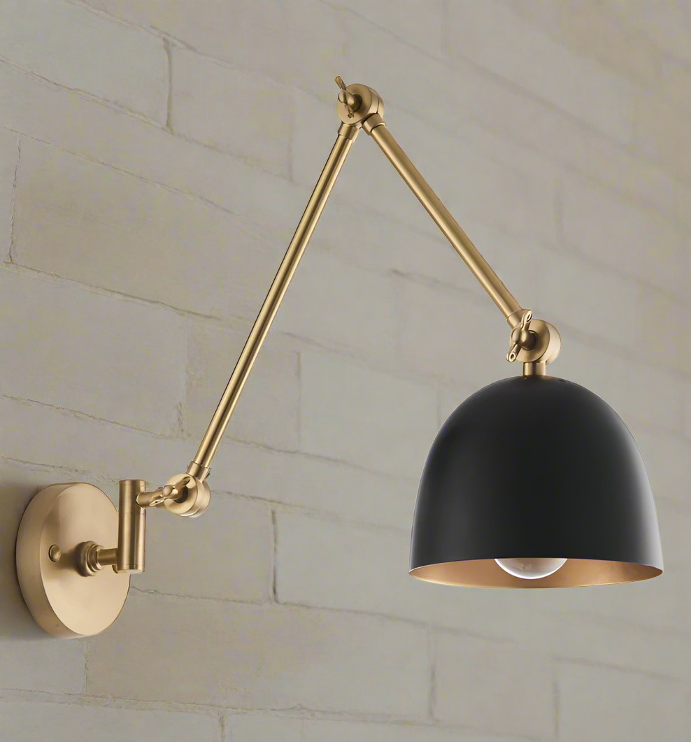 Gold flexible armed wall light with black shade. Industrial style wall light with extended arm. Great living room wall light, perfect in a kitchen or over a dining table.
