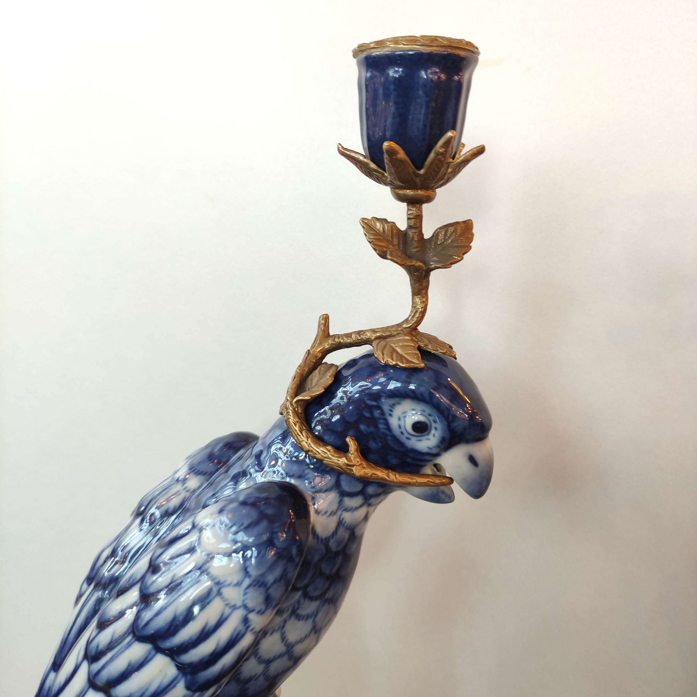 Bronze and porcelain parrot candle holders which are an exquisite reproduction of the Georgian originals. Beautifully made with the coloured porcelain parrots, topped with a bronze candle holder.