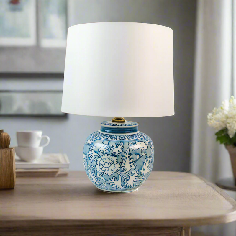 A really pretty smaller blue and white round based ceramic lamp with white shade. Perfect size for a smaller space, or a bedside lamp.