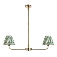 A refined ceiling light featuring an brass frame with two curved arms, each supporting a classic tapered fabric clip shade. 