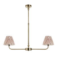 A refined ceiling light featuring an brass frame with two curved arms, each supporting a classic tapered fabric clip shade. 