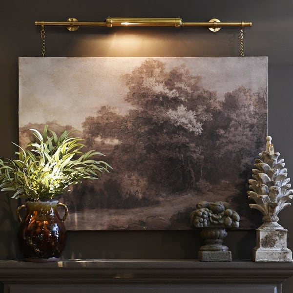 Elevate your artwork or wall décor with this elegant brass picture light, designed for both function and timeless style. Featuring a sleek cylindrical light bar in a warm brass finish, it casts an even, flattering glow across your painting or photograph. The fixture is mounted on a central pole, from which two decorative brass chains extend to secure it to the frame or wall, ensuring both stability and a sophisticated look.

Perfect for galleries, living rooms, or hallways, this brass picture light highligh
