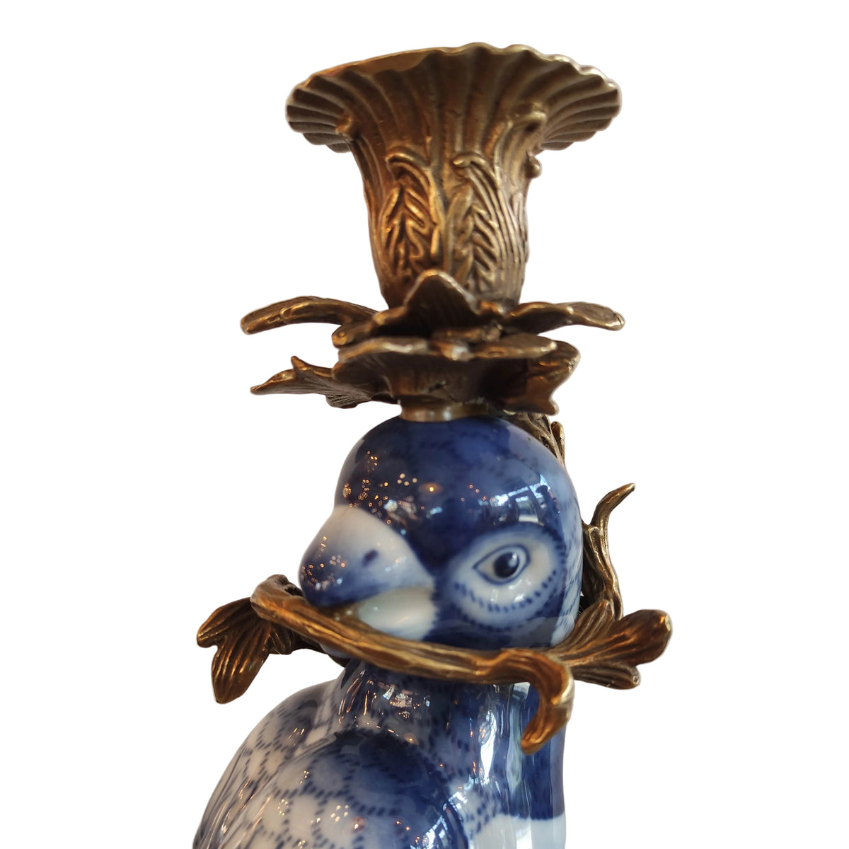 Decorative blue and white parrot candleholder close up.