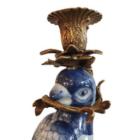 Decorative blue and white parrot candleholder close up.