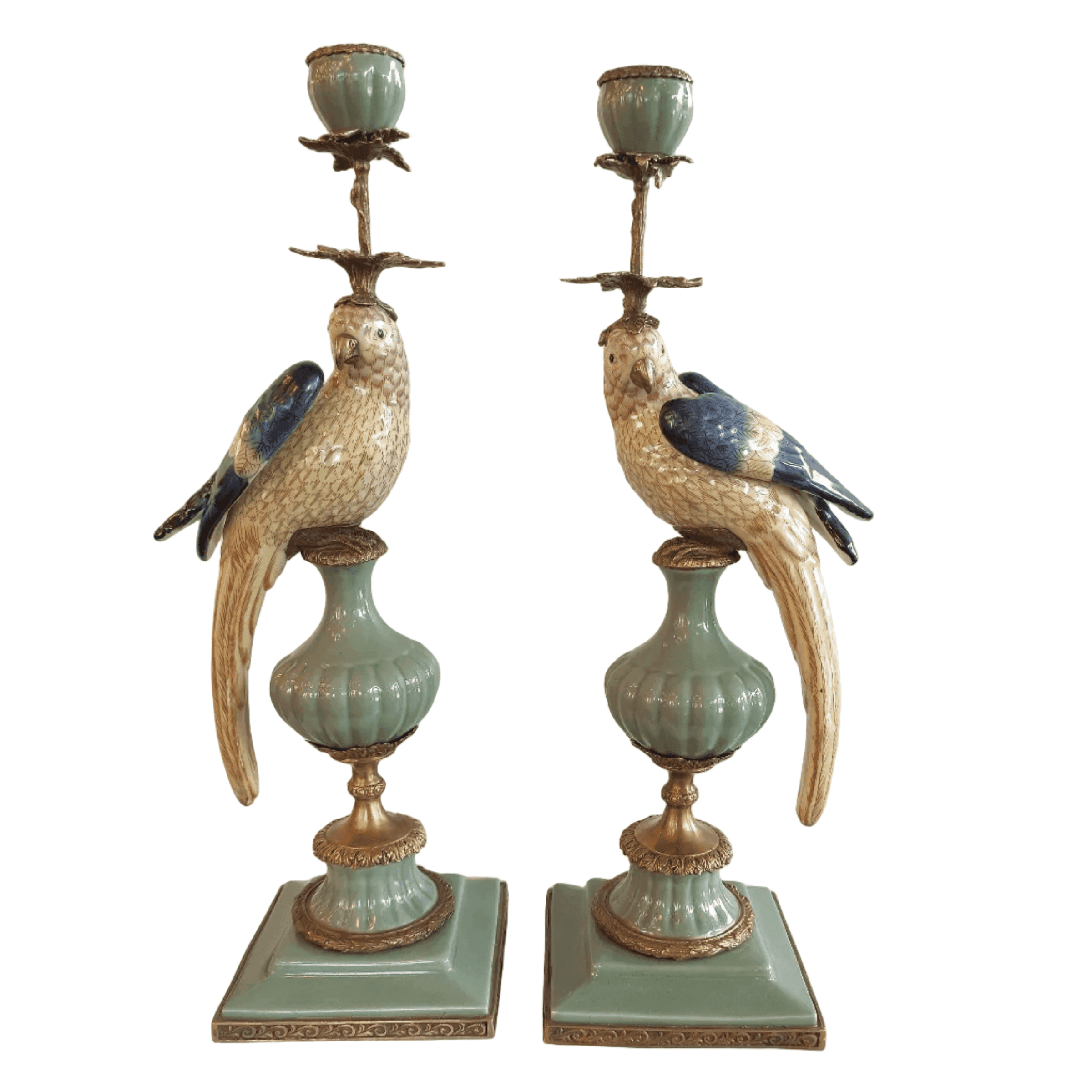 A pair of a colourful porcelain parrot candle holders with gilt bronze detailing. Crafted to exceptional quality, they add luxurious warmth and timeless charm to refined interiors