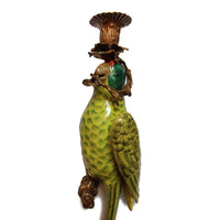 We now have our bronze and porcelain parrots as wall lights.&nbsp; These unusual candle holders would be a stunning focal point on any wall, comprising of bronze candle sconces linked to a scroll of bronze at the mouth of the parrot.&nbsp; The body of the parrot is stylised in a rich green glaze with feather detailing and elongated tails. They are exquisitely made and are an heirloom piece that will add luxury to your home.