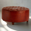 Buttoned round leather stool, sumptuous tobacco coloured leather on short wooden feet. A substantial size at over 1 metre wide, perfect coffee table stool in front of your sofa. With a large round tray on the surface to hold all your needs.

H: 50 cm W: 102 cm D: 102 cm&nbsp;