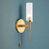 This stylish brushed gold and ribbed clear glass wall light has a IP44 rate. It is suitable for bathrooms and has a pull cord. It creates an instant classy and elegant feel.