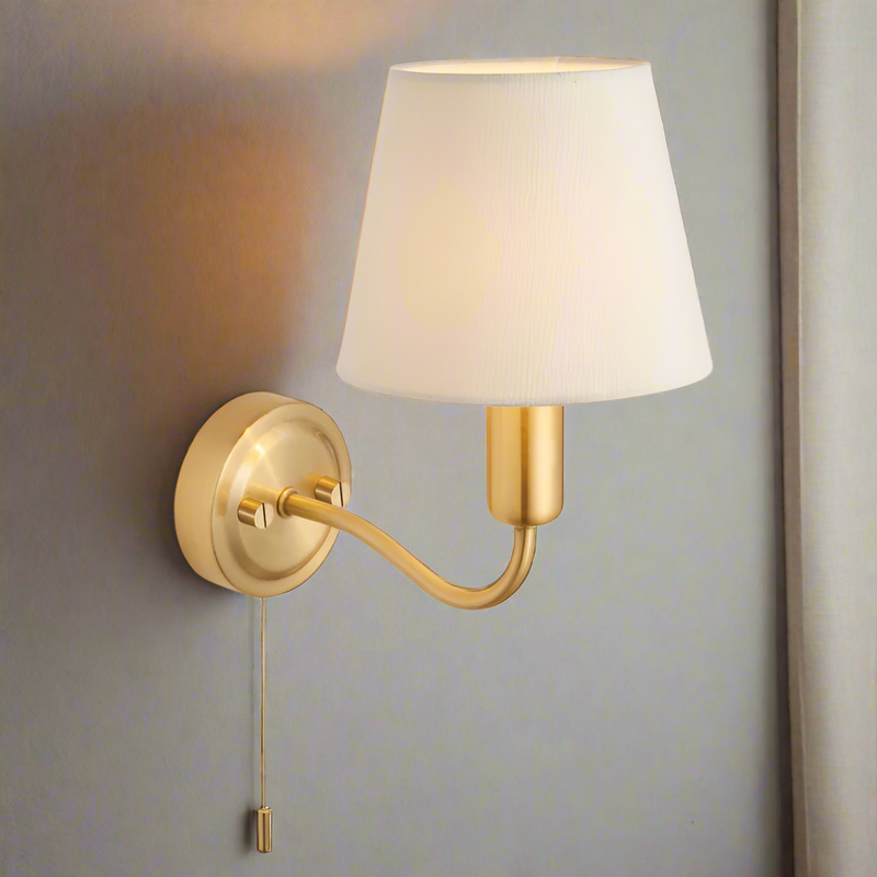 This stylish brass wall light with ivory shade has a IP44 rate. It is suitable for bathrooms and has a pull cord. 