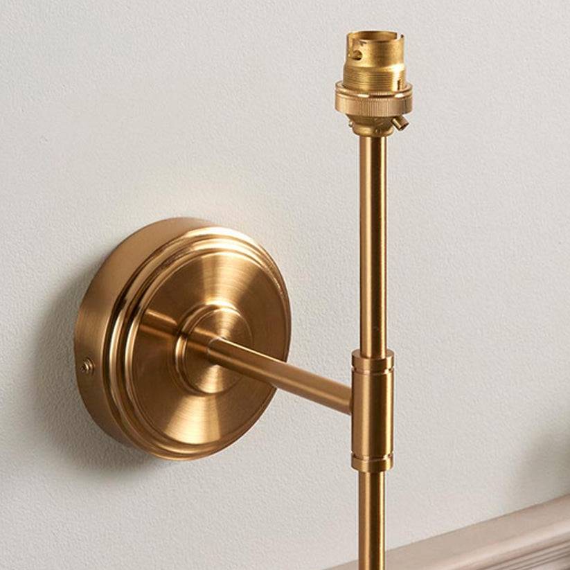 Very simple, classic shaded wall light in brushed aged brass. The neutral shade is a perfect addition, totally classic. This wall light is a great bedside lamp, situated on the wall