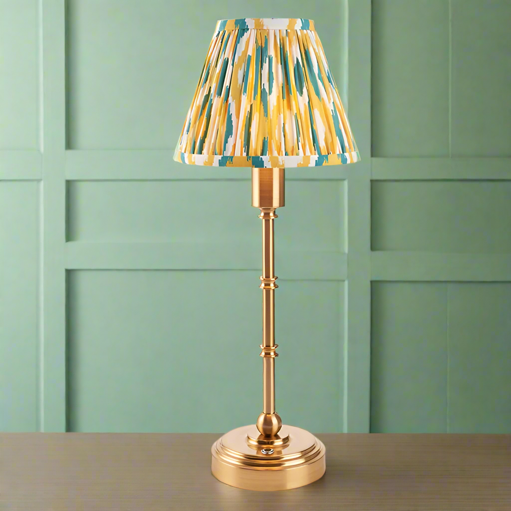 Brushed gold, rechargeable table lamp with a USB port.&nbsp; This portable, rechargeable 3 stage touch dimmer table lamp allows you to set your desired level of light.
They include a USB cable and an integrated warm white LED bulb.
These lamps are so convenient, can be placed wherever needed, no wires or plugs. Perfect for dining tables, desks or bedrooms. Can even be used outdoors making this a totally versatile lighting solution for your home.
Combine them with a beautiful pleated clip shade in four diffe