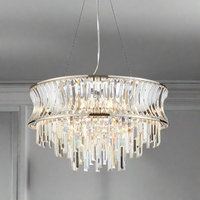 A beautiful nickel plated crystal chandelier. The light consists of a crystal band with a cascading drop of crystal prisms. An unusual large shaped chandelier, a really pretty fitting perfect for a living room or large hall,