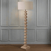 A really interesting notched, carved wooden floor lamp base, perfectly matched with a round linen shade of similar colour. Perfect neutral colour to blend in any interior. 