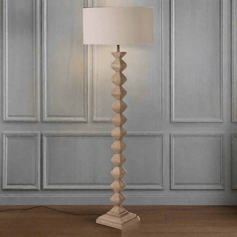 A really interesting notched, carved wooden floor lamp base, perfectly matched with a round linen shade of similar colour. Perfect neutral colour to blend in any interior. 