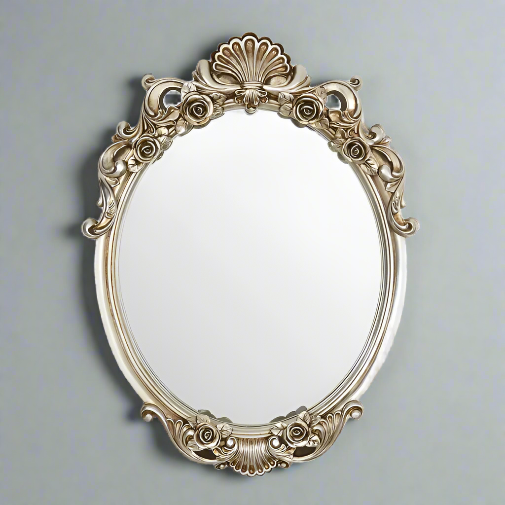 Exceptional oval mirror, very ornate with a carved frame and flourishes to the top and base, great vintage looking mirror in a soft champagne silver. A classic shape perfect for a period home