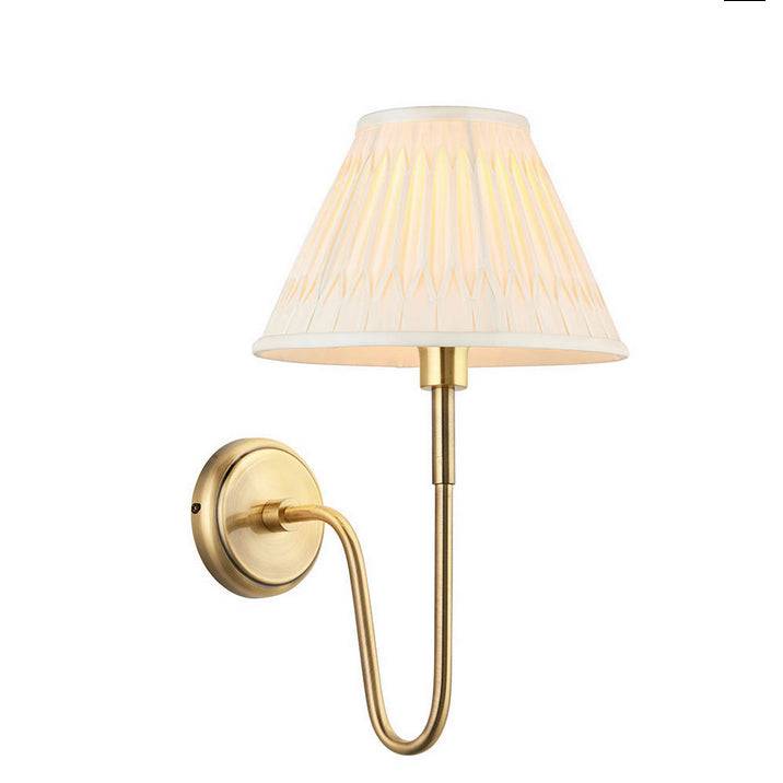 Curved brass wall light with a pleated fabric shade. Classic, slim wall light, a simple, elegant way to add light to you rooms.