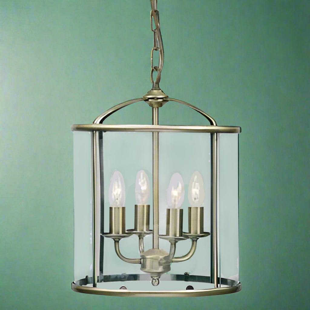 Traditionally shaped lantern in an antiqued brass finish with 4 lights, perfect country house on town house hall light.