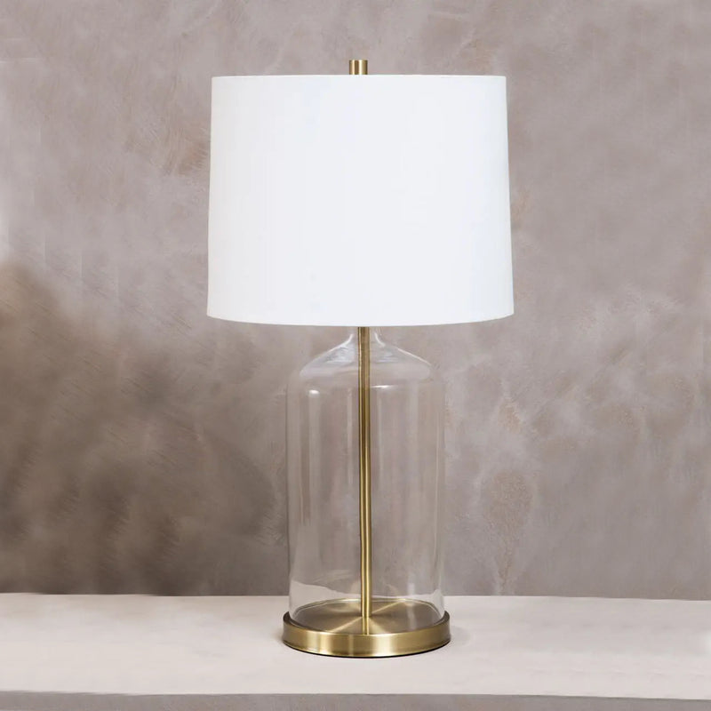 Tall classic glass lamp with gilt accents and a white fabric shade, perfect in any interior, a real statement lamp.&nbsp; Easy to place in a sitting room, dining room or even as bedside lamps. The light coming not just from the shade but enhanced by the glass base.


H: 65 cm W: 35 cm