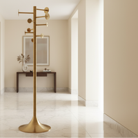 Designer freestanding brass coat stand styled in a luxury contemporary interior
