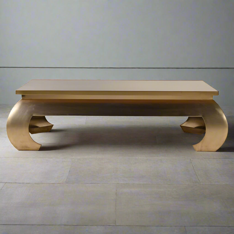 An extraordinary metal coffee table, the ultimate in glamorous furniture. Large enough to make a real statement in a room. This extra large gilt metal table is 140 cm wide and 80 cm deep so will make an enormous impact.&nbsp; &nbsp;Sleek, gilt metallic with exquisite , bold curved legs.&nbsp; It is Asian inspired modern glamour, an absolute stand out piece that would need to be in an ultra stylish area.&nbsp; It is almost a sculptural work of art but it is definitely also functional and needs to be used.&nb