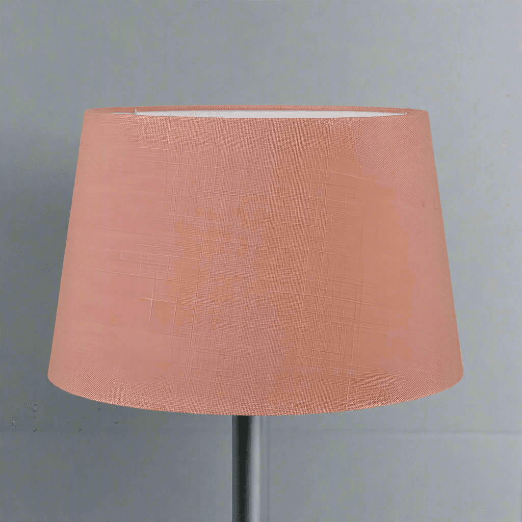 A beautiful coral / peach colour linen tapered lamp shade perfect to pair with a ceramic or stoneware lamp base. Available in five sizes.