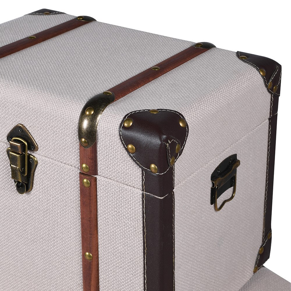 Vintage-style suitcase with brown straps and brass hardware on a white background