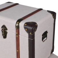 Vintage-style suitcase with brown straps and brass hardware on a white background