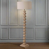 A really interesting notched, carved wooden floor lamp base, perfectly matched with a round linen shade of similar colour.&nbsp; Perfect neutral shade to blend into any interior.